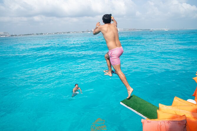 Dancer Cruise Isla Mujeres Snorkel Food and Drinks Included - Slide and trampoline time: the 30-minute ocean playground